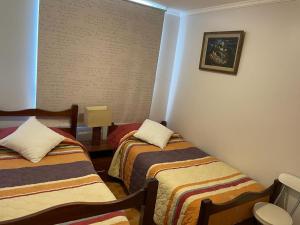 a room with two beds in a room at Apartment La Serena Pacifico in La Serena