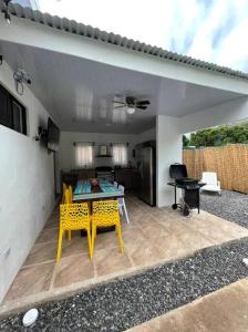 a patio with a table and chairs and a kitchen at Villa Congo by Villas Oasis Guacalillo in Tarcoles