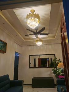 a living room with a ceiling fan and a mirror at DRS Legacy Homestay in Kamunting