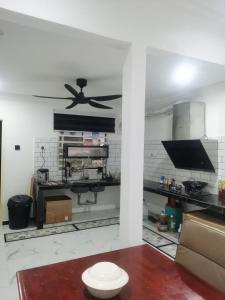a kitchen with a ceiling fan in a room at DRS Legacy Homestay in Kamunting