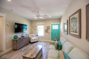 a living room with a couch and a tv at Bayside Cutie at Bayside Bungalow in Anna Maria