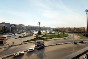 a busy city street with cars driving on a road at Travelholic 90 Residence in Cairo
