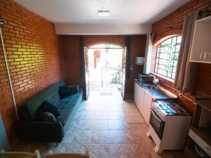 a living room with a couch and a brick wall at Residencial Colling in Canela