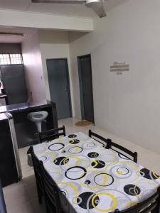 ein Zimmer mit einem Tisch und Stühlen in einem Zimmer in der Unterkunft RizqFateh Homestay in Keluang