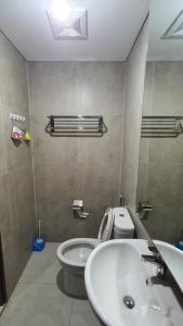 a bathroom with a sink and a toilet at Pollux Habibie Apartment Level 19 (Sea View) in Batam Center