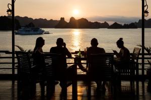 a group of people sitting at a table watching the sunset at Mila Lux Cruises in Ha Long +64 photos