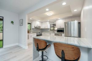 a kitchen with a counter and two bar stools at New! Miami & Calle Ocho Simpson's Funhouse! in Miami