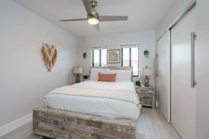 a bedroom with a large bed and a ceiling fan at New! Miami & Calle Ocho Simpson's Funhouse! in Miami