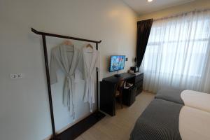 a hotel room with a robe hanging on a wall at YOLO Bangkok Boutique Hotel in Bangkok