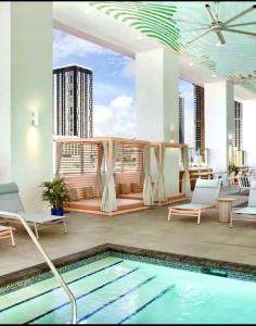 a living room with a swimming pool and a balcony at Comfortable Studio with King Bed and Queen Sofa-bed in Miami