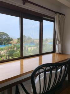 a chair sitting in front of a large window at Ao to Yuuhi - Vacation STAY 34462v in Tateyama