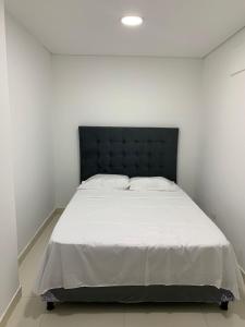 מיטה או מיטות בחדר ב-Apartahotel APR