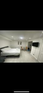 a bedroom with a bed and a television in it at St James Apartments in Leeds