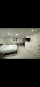a bedroom with a bed and a flat screen tv at St James Apartments in Leeds