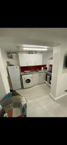 a kitchen with white cabinets and a stove top oven at St James Apartments in Leeds