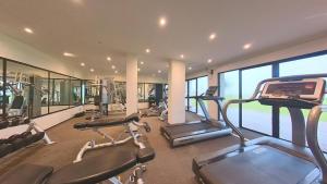 a gym with several treadmills and elliptical machines at EKHO Surf in Bentota