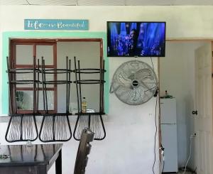 a fan is hanging on a wall next to a room at Casa Jaragua in Barra de Santiago