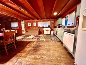 une cuisine avec un plafond en bois et une table dans l'établissement O Me, O Mio Cabin near the AuSable River, à Mio