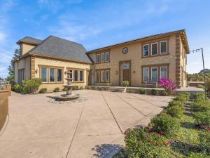 a large house with a courtyard in front of it at Luxury 4 Acre Estate - Pickleball, Pool, Hot Tub! in Lockeford