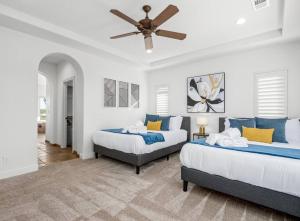 a bedroom with two beds and a ceiling fan at Luxury 4 Acre Estate - Pickleball, Pool, Hot Tub! in Lockeford +76 photos