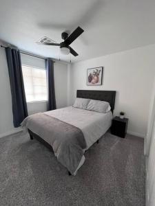 a bedroom with a bed and a ceiling fan at CasAHermosa Cozy getaway ! in Las Vegas