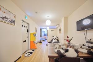 a living room with stuffed pandas sitting on the floor at TORA HOTEL Tokyo Ueno 寅ホテル 上野 B in Tokyo