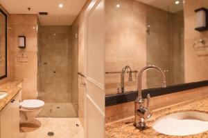 a bathroom with a sink and a toilet and a shower at CBD Executive Apartment right by the Harbour in Sydney