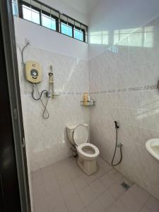 a bathroom with a toilet and a sink at Naura Roomstay in Sungai Petani
