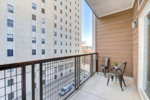 a balcony with chairs and a table and a building at Fancy Apt Downtown. Pool. Gym. Lounge. Pet OK in Houston