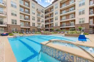 a swimming pool in a apartment complex with a building at Fancy Apt Downtown. Pool. Gym. Lounge. Pet OK in Houston