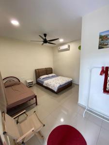 a bedroom with a bed and a ceiling fan at D’solok chalet in Kampong Pantai Ayer Hitam