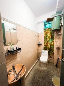 a bathroom with a toilet and a sink at Stay Cation “live like a local” in Gangtok