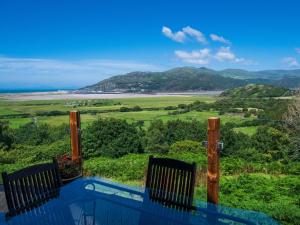 a view of the ocean from the balcony of a house at Treetops in Fairbourne