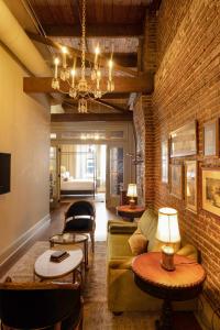 a living room with a couch and a brick wall at Hotel Cleo Knoxville in Knoxville