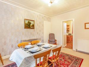 a dining room with a table and chairs at Isla Bank Cottage in Keith