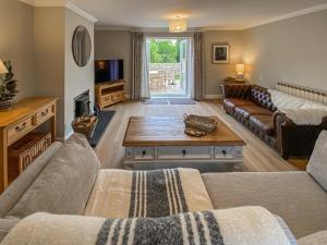 a living room with a couch and a coffee table at The Mill Lodge in Malmesbury