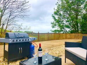 a grill and two glasses of wine on a table at Longmead in Berry Pomeroy