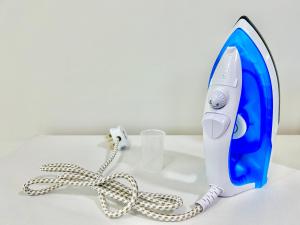 a blue and white hair dryer on a white table at Comfort Place 1-7 Pax 3 bedroom Ara Damansara in Petaling Jaya