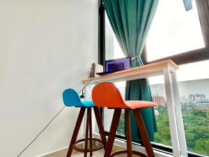 a table and two chairs in front of a window at Comfort Place 1-7 Pax 3 bedroom Ara Damansara in Petaling Jaya
