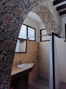 a bathroom with a sink and a mirror at Heritage Home, Hampe's in Mysore