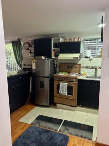 a kitchen with a stove and a sink at Cousy 2BR Condo in Virrey Walking distance to Andino & Parque 93 in Bogotá