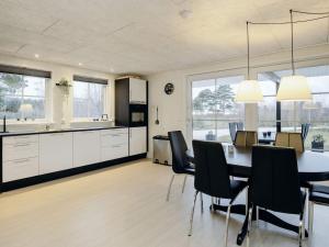 a kitchen and dining room with a table and chairs at Holiday home Læsø II in Læsø