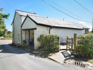 a small white building with a gate in front of it at 1 Bed in Westward Ho GATAB in Bideford