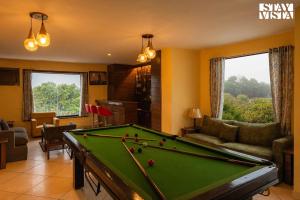 een woonkamer met een pooltafel. bij StayVista's Casba Farm Retreat - Pet-Friendly Villa with Rooftop Lounge, Outdoor Pool, Lawn & Bar in Chandīgarh