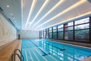 a large swimming pool with a large ceiling at Jin Jiang Hotel in Shanghai