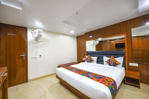a bedroom with a large bed in a room at FabHotel Mona International in New Delhi