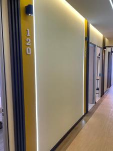 a hallway of an office with a yellow wall at Clock Inn Backpackers Hostel in Tanah Rata