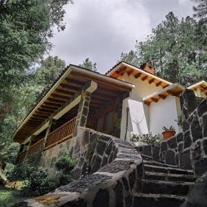 a house with stairs leading up to it at Los Azufres Spa Natural in Los Azufres