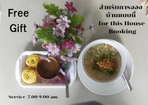 a picture of a vase of flowers and a bowl of soup at Bansuan Inthanon Eco Resort in Chom Thong