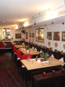 a restaurant with wooden tables and red chairs at Landgasthof Zum Hasen in Kleinwallstadt